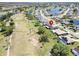 Aerial view of a residential home backing onto a golf course and a neighborhood with lakes at 2007 E View Dr, Sun City Center, FL 33573