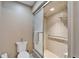 Bathroom featuring tiled walk-in shower, toilet, and accessible grab bar at 2007 E View Dr, Sun City Center, FL 33573
