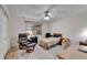 Bright bedroom with a ceiling fan, comfortable chair, desk, and patterned rug at 2007 E View Dr, Sun City Center, FL 33573