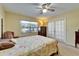 Bedroom with ceiling fan, closet and backyard views through bright window at 2007 E View Dr, Sun City Center, FL 33573