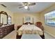 Bedroom with a four-poster bed, floral patterned quilt, and a dresser at 2007 E View Dr, Sun City Center, FL 33573