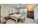 Comfortable bedroom with a four-poster bed, floral patterned quilt, and matching furniture at 2007 E View Dr, Sun City Center, FL 33573