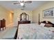 Bright bedroom with a traditional wooden dresser and floral bedding, creating a cozy and inviting atmosphere at 2007 E View Dr, Sun City Center, FL 33573