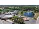 Aerial shot showcasing the community center with tennis courts, lake with fountain, and lush landscaping at 2007 E View Dr, Sun City Center, FL 33573