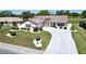 Charming single-story home with a well-manicured lawn, curved driveway, and beautiful landscaping at 2007 E View Dr, Sun City Center, FL 33573