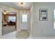 Bright foyer featuring tile flooring, a decorative front door, and a view into the adjacent living space at 2007 E View Dr, Sun City Center, FL 33573