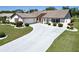 Inviting single-Gathering home featuring a manicured lawn, attractive landscaping, and a spacious driveway at 2007 E View Dr, Sun City Center, FL 33573