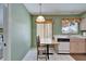 Eat-in kitchen nook featuring tile floors, table with chairs, and green walls at 2007 E View Dr, Sun City Center, FL 33573