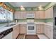 Kitchen featuring white cabinets, tile countertops, and stainless steel sink at 2007 E View Dr, Sun City Center, FL 33573