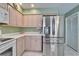 Kitchen with stainless steel refrigerator, white cabinets, and modern appliances at 2007 E View Dr, Sun City Center, FL 33573