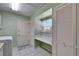 Bright laundry room with washer, dryer, and built-in counter space and white tile flooring at 2007 E View Dr, Sun City Center, FL 33573
