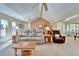 Spacious living room with vaulted ceilings, ceiling fan, and lots of natural light from surrounding windows at 2007 E View Dr, Sun City Center, FL 33573