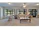 Bright sunroom with large windows offering beautiful outdoor views and neutral decor at 2007 E View Dr, Sun City Center, FL 33573