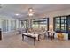 Bright sunroom featuring large windows with views of the backyard and a comfortable seating area at 2007 E View Dr, Sun City Center, FL 33573