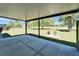Covered patio offers a peaceful view of the lush green backyard and surrounding landscape at 2007 E View Dr, Sun City Center, FL 33573