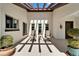 Open patio with seating beneath a pergola, potted plants, and windows creating a cozy outdoor space at 2007 E View Dr, Sun City Center, FL 33573