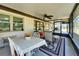 Covered patio features a ceiling fan, dining area, and seating area with nice views at 2007 E View Dr, Sun City Center, FL 33573