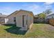 View of a small backyard featuring a compact structure with an open door and partial fencing at 2125 W Cypress St, Tampa, FL 33606