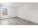 Bright bedroom with wood-look flooring, white walls, and a window offering natural light at 2125 W Cypress St, Tampa, FL 33606