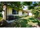 Backyard featuring green grass, a row of hedges, and an air conditioning unit at 2254 Sequoia Dr, Clearwater, FL 33763