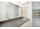 Bathroom vanity featuring a gray countertop, white sink, and a decorative mirror at 2254 Sequoia Dr, Clearwater, FL 33763