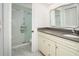 Bright bathroom featuring a marble floor, a shower with glass doors, and a vanity with granite countertop at 2254 Sequoia Dr, Clearwater, FL 33763