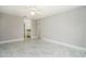 Bright bedroom features tile flooring, a ceiling fan, a closet, and an ensuite bathroom for optimal convenience at 2254 Sequoia Dr, Clearwater, FL 33763