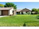 Inviting single-story home featuring a well-kept lawn, attached garage, and charming front exterior at 2254 Sequoia Dr, Clearwater, FL 33763