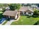 Well-maintained single-story home with a lush green lawn, an attached garage, and mature landscaping at 2254 Sequoia Dr, Clearwater, FL 33763