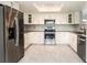 Modern kitchen features updated stainless steel appliances, lots of counterspace, and ample storage within reach at 2254 Sequoia Dr, Clearwater, FL 33763