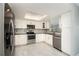 Modern kitchen features stainless steel appliances, white cabinets, and plenty of natural light from above at 2254 Sequoia Dr, Clearwater, FL 33763