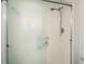 Shower features sliding glass door, a shower head and a built-in shelf for toiletries at 2254 Sequoia Dr, Clearwater, FL 33763