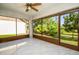 The sun room features tile flooring and screens that offer views of the lush tropical greenery outside at 2254 Sequoia Dr, Clearwater, FL 33763