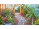 Backyard entrance featuring a stone pathway and a decorative wooden gate at 2501 Emerson S Ave, St Petersburg, FL 33712