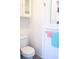 Clean bathroom with a white toilet, beadboard wainscoting, and towel rack for a fresh and functional space at 2501 Emerson S Ave, St Petersburg, FL 33712