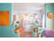 Open-concept living room flows into the kitchen with unique decor and vibrant turquoise walls at 2501 Emerson S Ave, St Petersburg, FL 33712