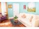 Bright living room with hardwood floors, white sofa with decorative pillows, and stylish art on the walls at 2501 Emerson S Ave, St Petersburg, FL 33712