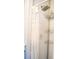 Bright shower with a rain shower head, chrome caddy and a patterned shower curtain and clean white subway tile at 2501 Emerson S Ave, St Petersburg, FL 33712