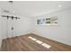 Bright bedroom with recessed lighting, modern sliding barn door, and a window letting in natural light at 2650 E Vina Del Mar Blvd, St Pete Beach, FL 33706
