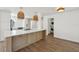 Kitchen island with modern appliances, stylish pendant lighting, and convenient access to laundry at 2650 E Vina Del Mar Blvd, St Pete Beach, FL 33706