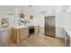 Bright, updated kitchen with stainless steel appliances, white countertops, and a wooden island with modern lighting at 2650 E Vina Del Mar Blvd, St Pete Beach, FL 33706