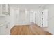 Spacious living room featuring white cabinets, hardwood floors, and open hallway access at 2650 E Vina Del Mar Blvd, St Pete Beach, FL 33706
