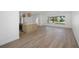 Bright living area with wood flooring, adjacent to a kitchen island and a view of the front yard at 2650 E Vina Del Mar Blvd, St Pete Beach, FL 33706