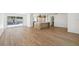 Open-concept living space with wood floors, a kitchen island, and natural light from sliding glass doors at 2650 E Vina Del Mar Blvd, St Pete Beach, FL 33706