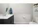 This bathroom has a white vanity with white countertops and modern fixtures at 2760 Scarlet Bay Pl, Brandon, FL 33510