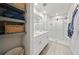 Bright bathroom with double sinks, framed mirrors, and a glass-enclosed shower; features open shelving at 2760 Scarlet Bay Pl, Brandon, FL 33510