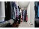 Walk-in closet filled with organized clothing, shoes, and storage containers at 2760 Scarlet Bay Pl, Brandon, FL 33510