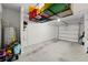 The spacious garage features high ceilings and overhead storage racks at 2760 Scarlet Bay Pl, Brandon, FL 33510