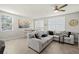 This living room has large windows for lots of light, tile floors and neutral colors at 2760 Scarlet Bay Pl, Brandon, FL 33510