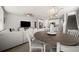 Open-concept living room with modern furnishings, stairs, and an eat-in kitchen visible in the background at 2760 Scarlet Bay Pl, Brandon, FL 33510